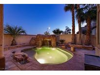 Inviting pool with a waterfall feature, perfect for relaxation at 2104 Stone Croft St, Las Vegas, NV 89134