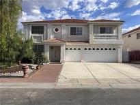 Two-story house with a three-car garage and landscaped front yard at 577 Leap Frog Ave, Las Vegas, NV 89183
