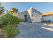 Single-story home with attached garage and landscaping at 2302 El Molino Cir, Las Vegas, NV 89108