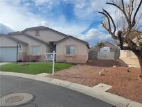 One-story house with desert landscaping and a two-car garage at 3535 Chimes Dr, North Las Vegas, NV 89032