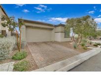 Single-story home with a two-car garage and landscaped front yard at 372 Cooper Hawk Ct, Las Vegas, NV 89138