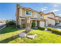 Two-story house with stone accents, a large yard, and a two-car garage at 8401 Dunphy Ct, Las Vegas, NV 89145