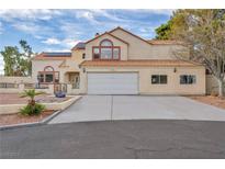 Two-story house with attached garage and landscaping at 4571 N Chieftain St, Las Vegas, NV 89129