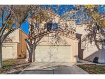 Two-story house with attached garage and landscaping at 5481 Overland Express St, Las Vegas, NV 89118