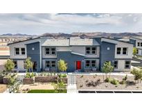 Modern 2-story townhome with red door, landscaped yard, and mountain views at 4854 Currant Ridge Ave # 67, Las Vegas, NV 89141