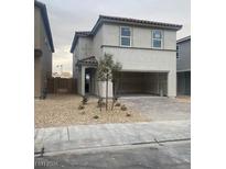 Two-story house with attached garage and landscaping at 9252 Morecambe Ave, Las Vegas, NV 89148