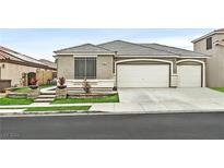 Single-story house with a three-car garage and well-manicured landscaping at 963 Mill Run Creek Ave, Henderson, NV 89002