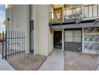 Exterior view of a building with walkway, gated entrance, and individual unit entrance at 1440 Vegas Valley Dr # 9, Las Vegas, NV 89169