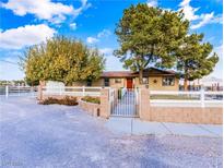 Ranch style home with a gated entrance, landscaped yard, and a spacious driveway at 9350 Homestead Rd, Las Vegas, NV 89143