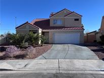 Two-story house with a red tile roof, attached garage, and landscaping at 1706 Toltec Cir, Henderson, NV 89014