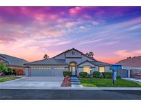 Single-story home with a two-car garage and manicured lawn at 233 Molly Ct, Las Vegas, NV 89183