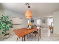 Bright dining room with mid-century modern table and light fixture at 11016 Rossi Ave, Las Vegas, NV 89144