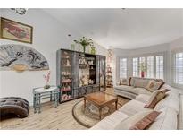 Bright living room featuring a comfortable sectional sofa and decorative shelving at 5320 Rebecca Rd, Las Vegas, NV 89130