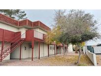 Red building exterior with stairs and landscaping at 5324 Swenson St # 60, Las Vegas, NV 89119