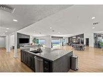 Open concept kitchen with large island, modern appliances, and ample counter space at 6971 Arville St, Las Vegas, NV 89118