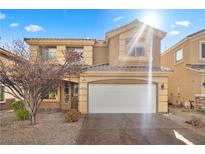 Two-story house with attached garage and landscaped front yard at 135 Tall Ruff Dr, Las Vegas, NV 89148