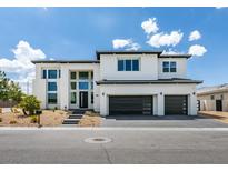 Two-story modern home with three-car garage and landscaped front yard at 3423 Spanish Winds Ct, Las Vegas, NV 89141