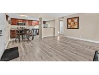 Open living room with wood-look floors and kitchen access at 5021 River Glen Dr # 47, Las Vegas, NV 89103