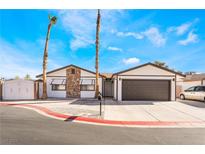 Single-story home with attached garage and palm trees at 4810 Palacio Ct, Las Vegas, NV 89122