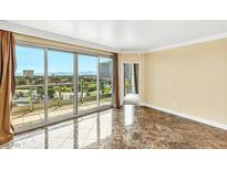 Bright living room with marble floors and sliding doors leading to a balcony with city views at 322 Karen Ave # 903, Las Vegas, NV 89109