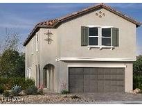 Two-story house with tan siding, brown garage door, and landscaping at 6574 Tumoulin St, Las Vegas, NV 89148