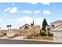 Two-story house with attached garage and landscaped front yard at 3217 Harbor Vista St, Las Vegas, NV 89117