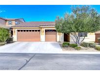 Two-car garage and landscaped front yard at 6644 Fort William St, North Las Vegas, NV 89084