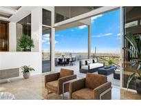 View of a patio with seating area and city views, accessed through sliding glass doors at 1484 Macdonald Ranch Dr, Henderson, NV 89012