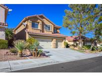 Two-story house with three-car garage, landscaping, and a large tree in the front yard at 2033 Sedona Creek Cir, Las Vegas, NV 89128