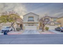 Two-story townhome with attached garage and landscaping at 6525 Raven Hall St, North Las Vegas, NV 89084