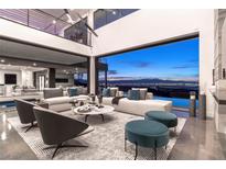 Open living room with city views, modern furniture, and high ceilings at 669 Dragon Peak Dr, Henderson, NV 89012