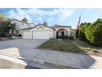 Two-story house with a three-car garage and landscaped front yard at 923 Highland Trails Ave, Henderson, NV 89015