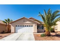 Tan one-story house with a two-car garage and desert landscaping at 5010 Sail Rock Pl, North Las Vegas, NV 89031