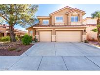 Inviting two-story home with a three-car garage and landscaped front yard at 8229 Sedona Sunrise Dr, Las Vegas, NV 89128