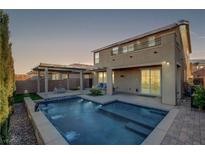 Stunning backyard with a sparkling pool, covered patio & firepit at 924 Monte Nerone Ave, Henderson, NV 89012