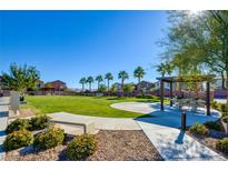 Community park with grassy area, covered seating, and playground at 5029 Bloodhound St, Las Vegas, NV 89122