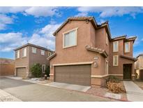 Two-story townhome with attached garage and landscaping at 649 Taliput Palm Pl, Henderson, NV 89011