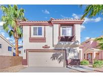 Two-story house with beige and brown exterior, two-car garage, and landscaping at 9316 Perennial Ave, Las Vegas, NV 89148