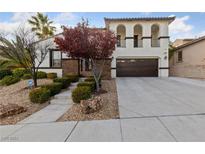 Two-story house with stucco exterior, landscaped yard, and a three-car garage at 12253 Bluebird Canyon Pl, Las Vegas, NV 89138