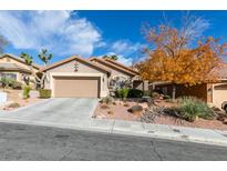 Single-story house with attached garage and landscaped front yard at 10604 Royal Willow Pl, Las Vegas, NV 89144