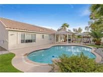 Inviting kidney-shaped pool with a pergola and spacious backyard at 1117 Stable Glen Dr, North Las Vegas, NV 89031