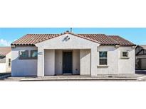 Single-story home with a terracotta tile roof and a gray exterior at 743 Armstrong Hills St, Henderson, NV 89011