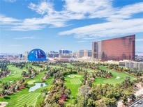 Aerial view showcasing a golf course with luxurious high-rise buildings in the background at 360 E Desert Inn Rd # 1803, Las Vegas, NV 89109