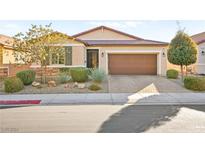 Single-story home with a brown garage door and well-manicured landscaping at 4133 Fairywren Dr, North Las Vegas, NV 89031