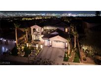 Luxury home with stunning city views at night, showcasing a large backyard and beautiful landscaping at 2781 Josephine Dr, Henderson, NV 89044