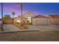 One-story house with a landscaped front yard, driveway, and attached garage at 6101 Pahoehoe Way, North Las Vegas, NV 89031