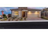 Single-story home with stone accents and a two-car garage at 912 Calluna Hills Ln, Las Vegas, NV 89138