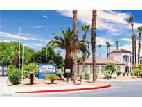 Exterior view of Coral Palms Condominiums, showcasing a well-maintained building and landscaping at 3318 N Decatur Blvd # 1013, Las Vegas, NV 89130