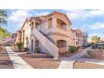 Two-story condo building with stairs and walkway at 5751 E Hacienda Ave # 261, Las Vegas, NV 89122