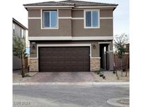 Two-story home with a paved driveway and attached two-car garage at 10205 Starlit Canyon Ct, Las Vegas, NV 89141